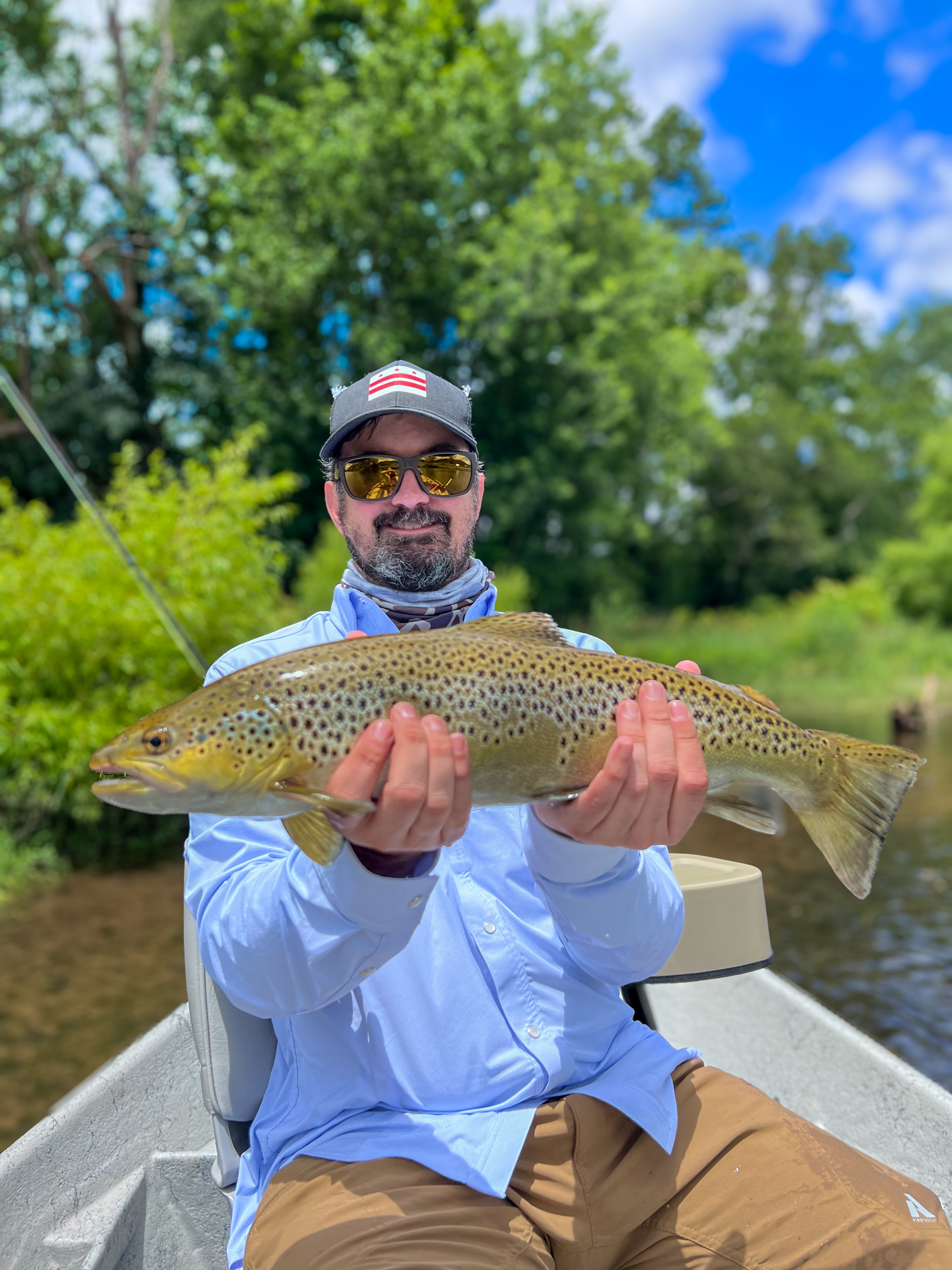 Taylour holding a brown trout